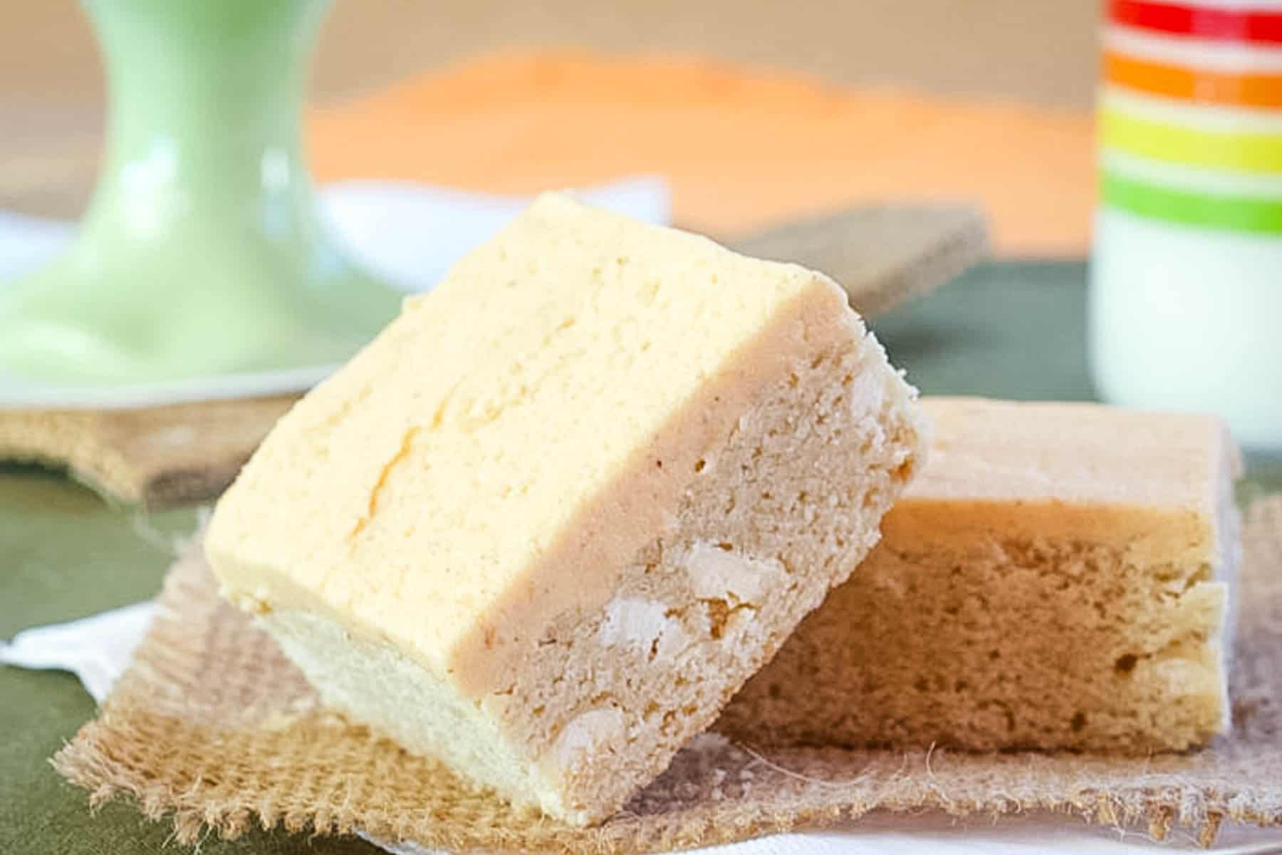 One pumpkin-frosted sugar cookie bar leaning against another one.