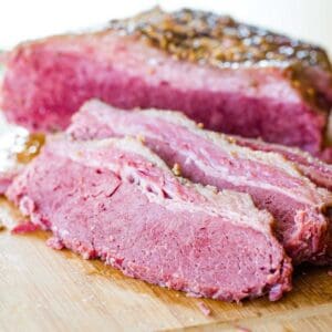 Sliced corned beef brisket on a cutting board.