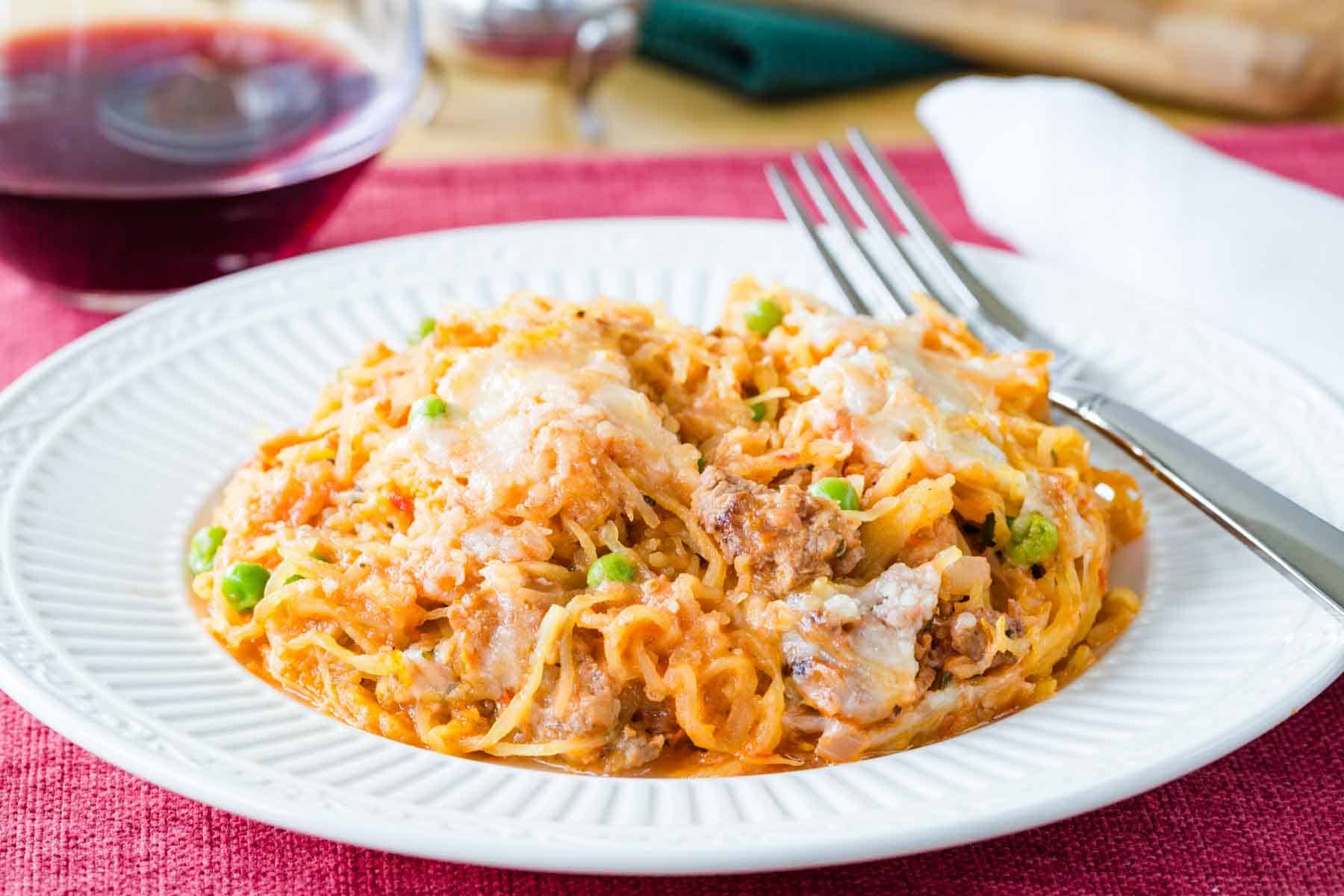 A serving of spaghetti squash casserole on a plate with a fork.