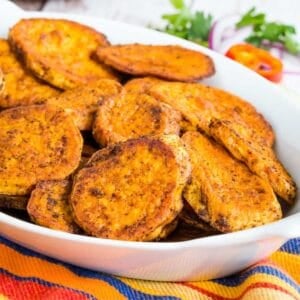 Spicy Baked Sweet Potato Slices in a white serving dish.