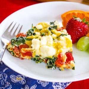 Tomato Feta Spinach Frittata on a white plate.
