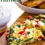 Pieces of frittata with spinach, tomatoes, and feta on a cutting board with text overlay that says "Spinach Frittata".