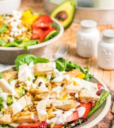 A strawberry mango salad with chicken, avocado, and other ingredients.