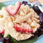 A closeup of creamy quinoa chicken salad with strawberries with text overlay that says "Strawberry Quinoa Chicken Salad".