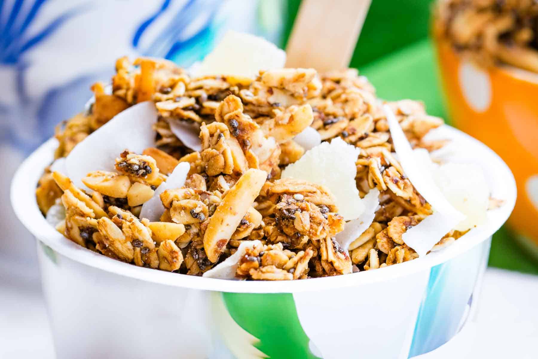 Tropical granola on top of a yogurt container.