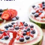 Powdered sugar being sprinkled over a round slice of watermelon topped with berries and whipped cream with text overlay that says "Watermelon Pizza".