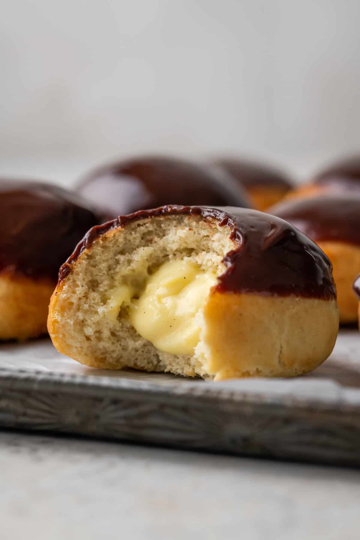 The interior of pastry cream is shown on a donut.