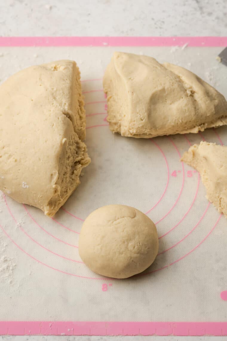 Donut dough is cut and shaped into donuts.