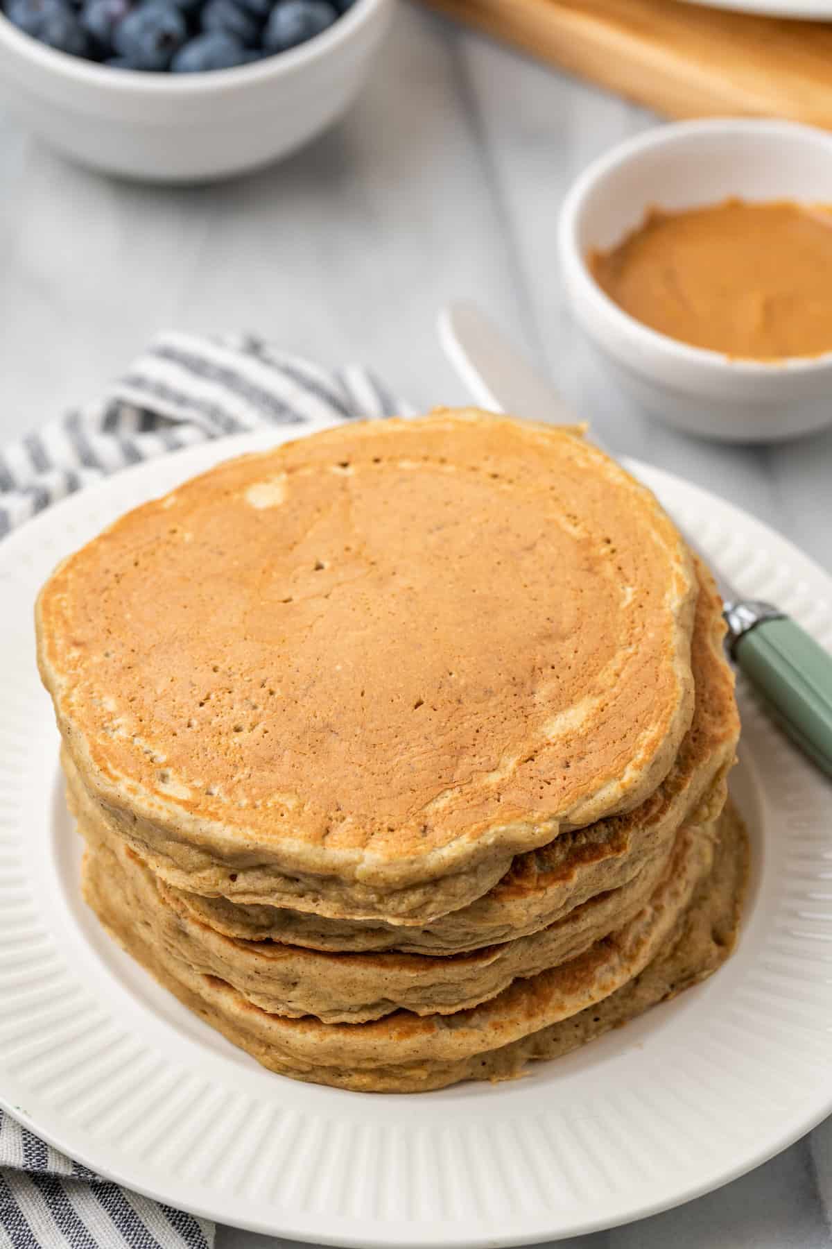 A stack of gluten-free protein pancakes on a plate.