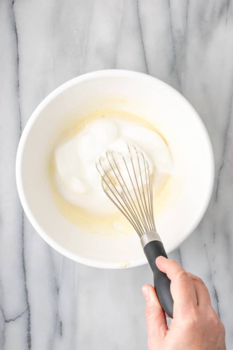 Whisking egg whites into pancake batter.