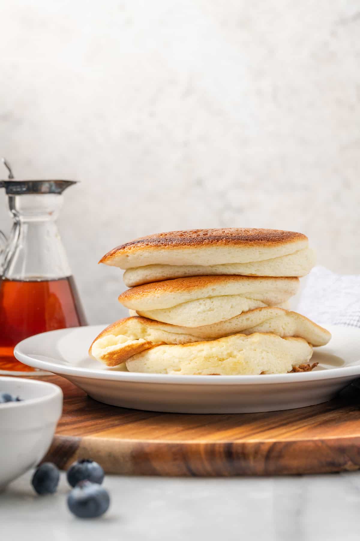 A stack of gluten-free souffle pancakes is shown on a plate.