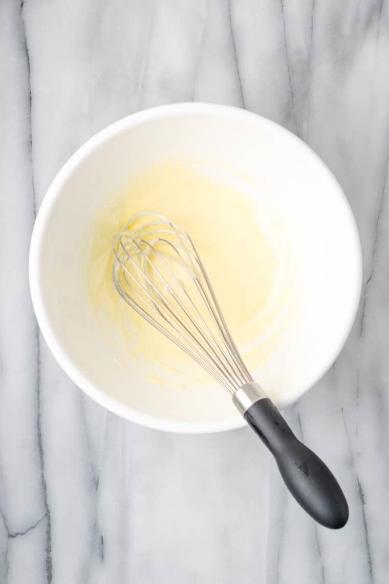 Gluten-free souffle pancake batter is whisked in a bowl.