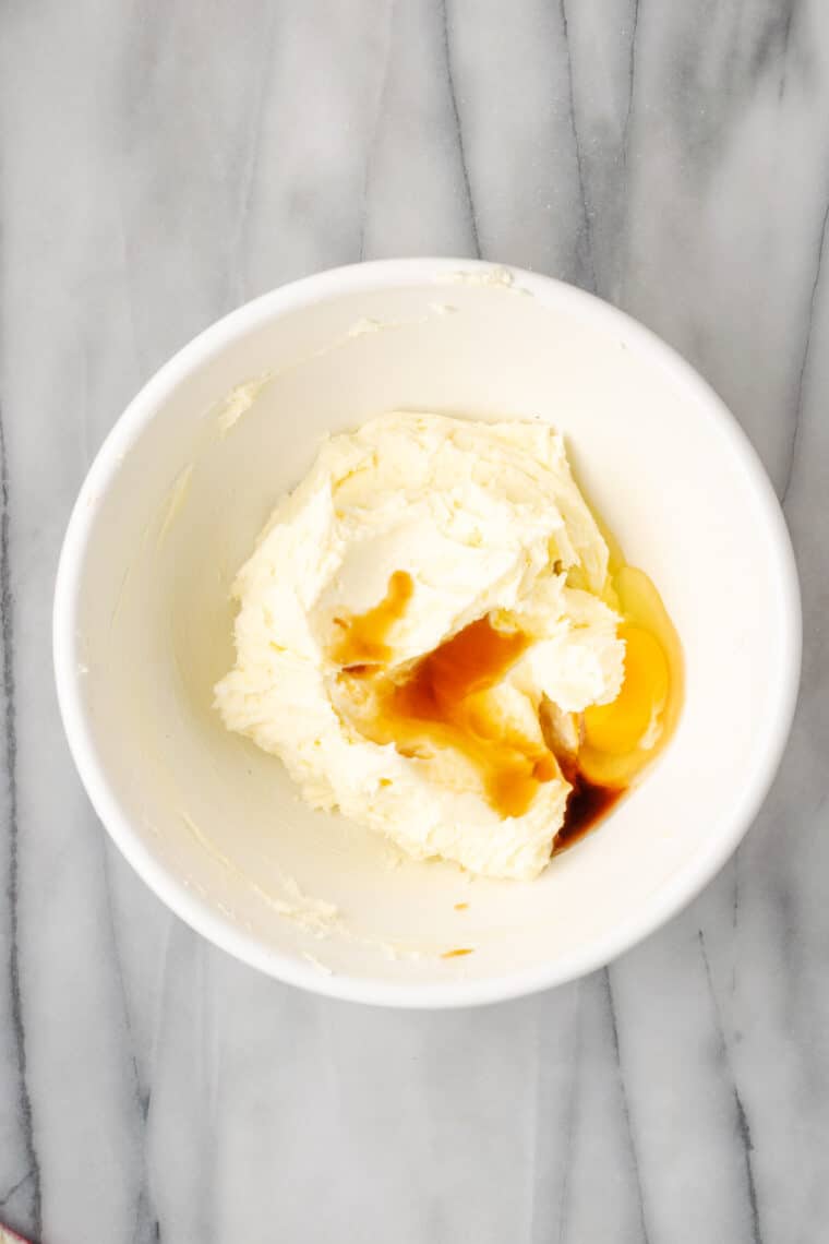 Vanilla is stirred into cream cheese.