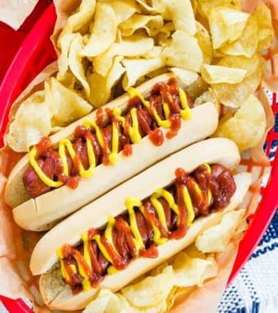 Cooked air fryer hot dogs are served in buns with condiments.