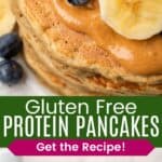 A closeup of the top of a stack of pancakes topped with peanut butter, blueberries, and banana slices and the stack on a plate from the side divided by a green box with text overlay that says "Gluten Free Protein Pancakes" and the words "Get the Recipe!".