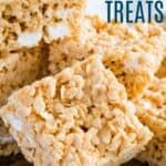 A stack of rice krispie treats on a wooden board with the one in front propped up against the pile with text overlay that says "Gluten Free Rice Krispies Treats".