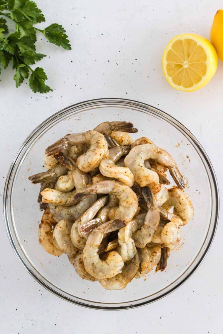 Shrimp is shown in a glass bowl on a white background.