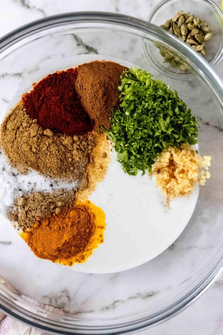 Spices needed to make a chicken marinade in a bowl.