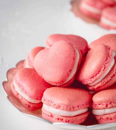 A pile of heart-shaped strawberry macarons.