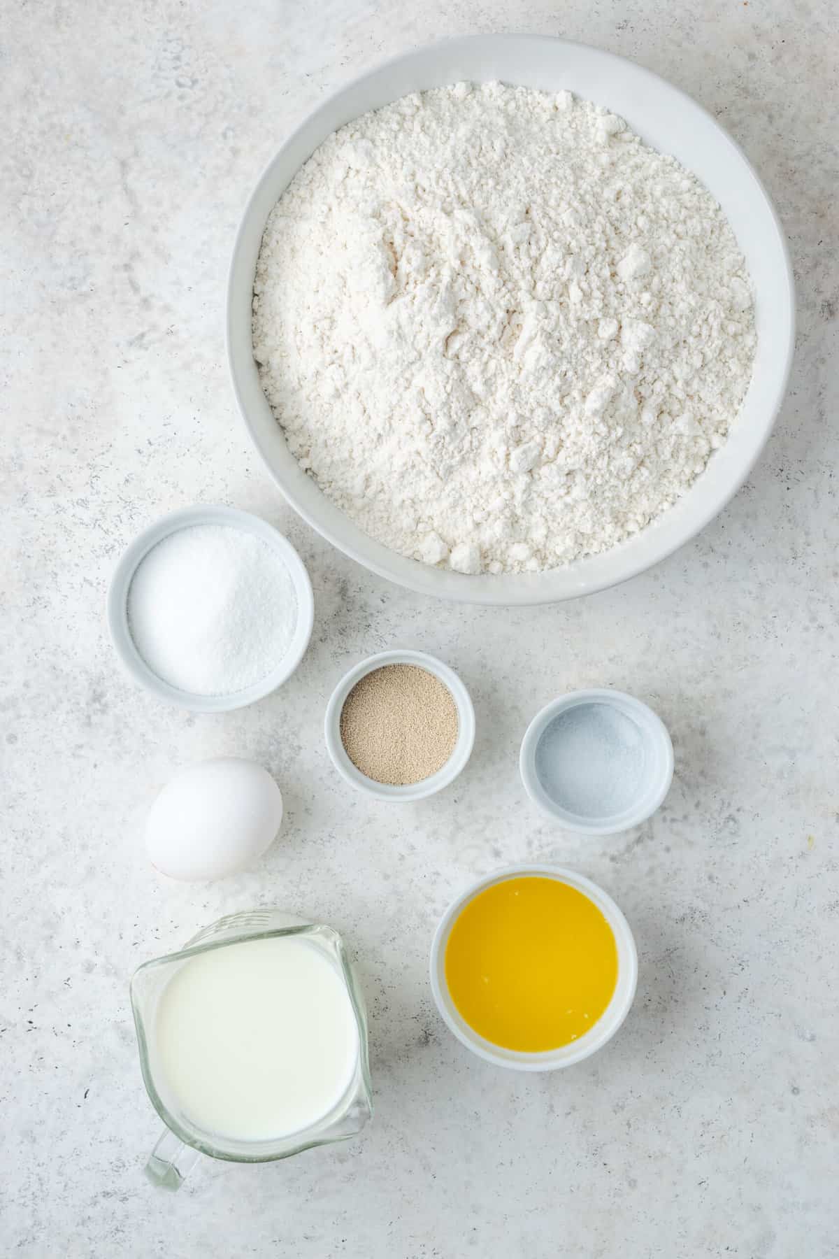 Ingredients needed to make gluten-free donuts are shown, including  eggs, yeast and butter.