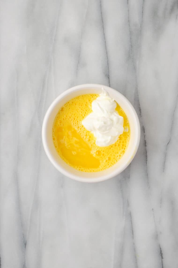 Yogurt is stirred into a butter-egg mixture.