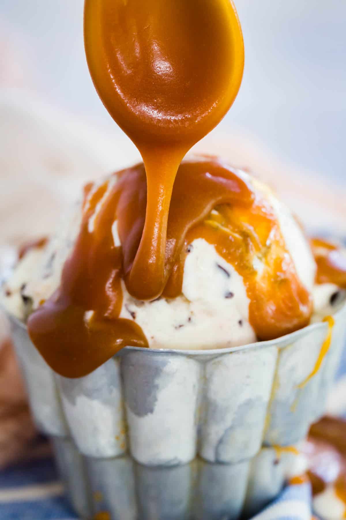 Pouring caramel sauce over ice cream.