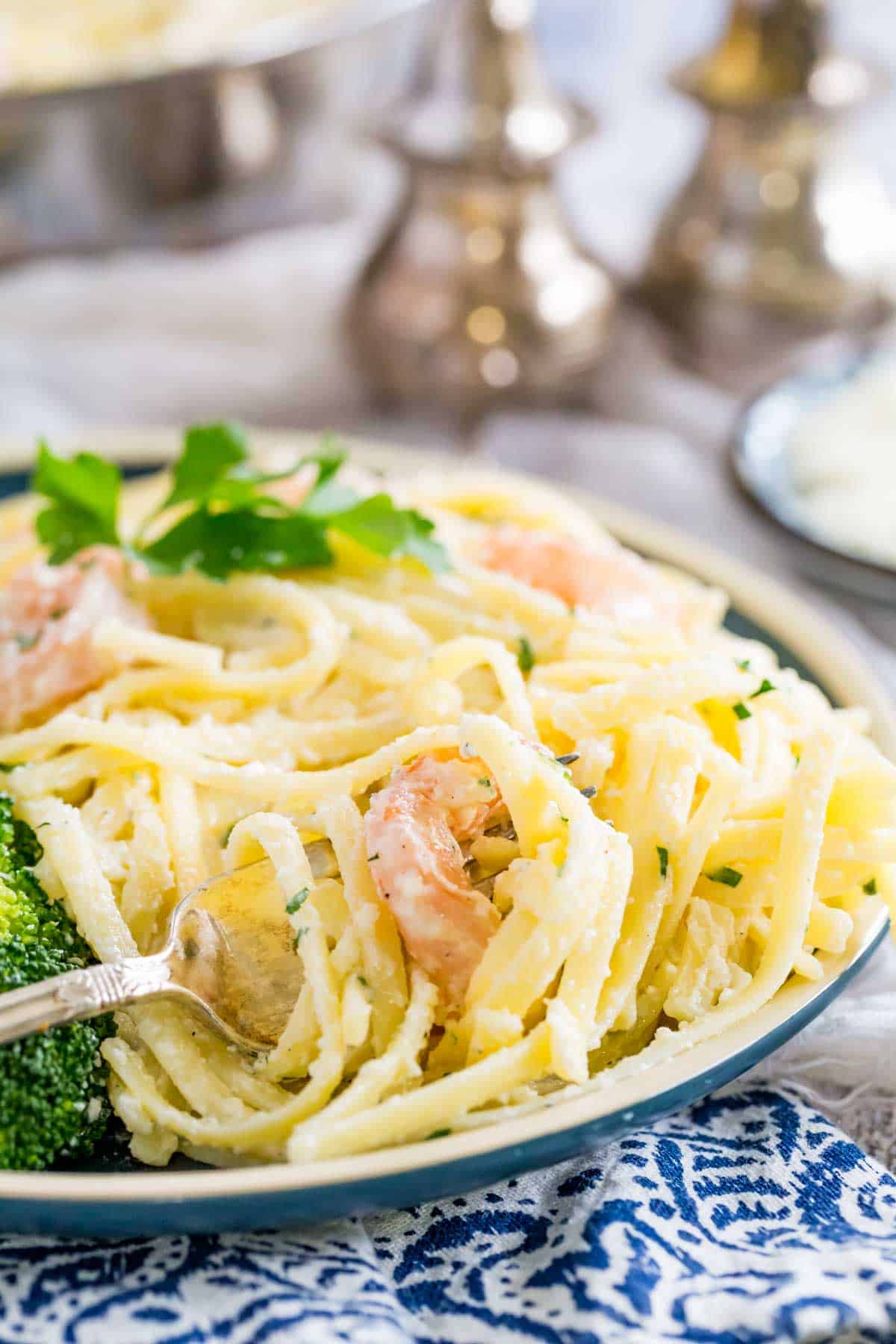 A plate of gluten-free shrimp alfredo with a fork.