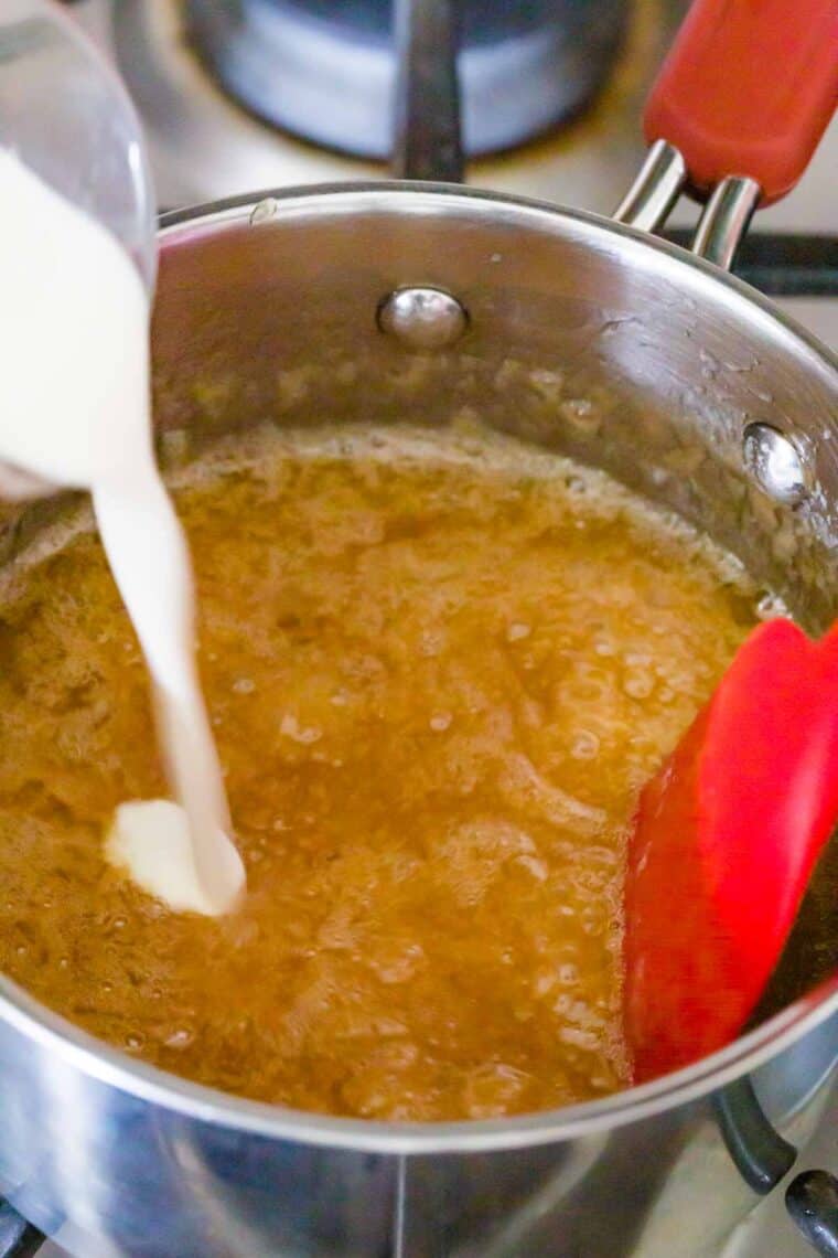 Pouring cream into caramel sauce.