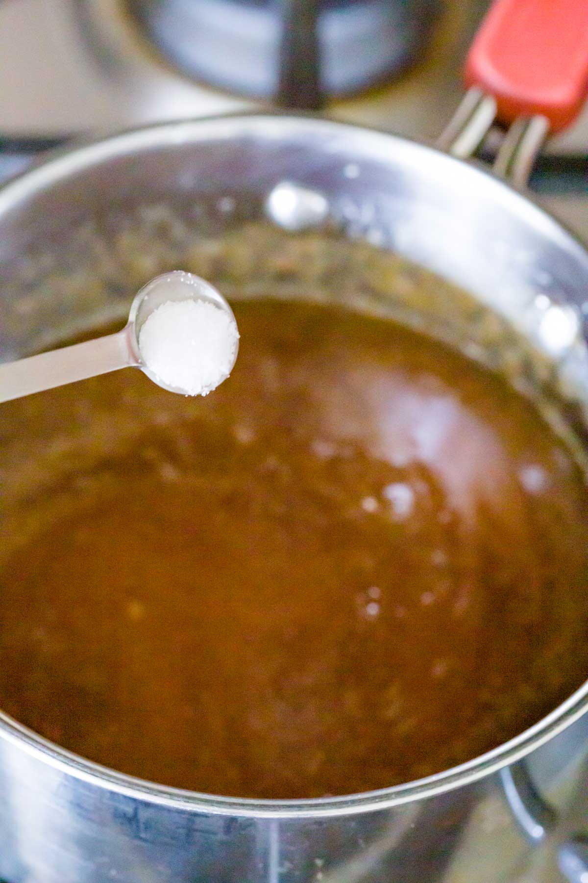Adding cream to caramel sauce.