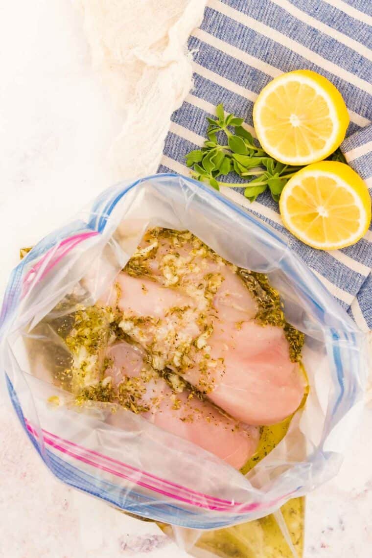 Marinating chicken in a Greek marinade.