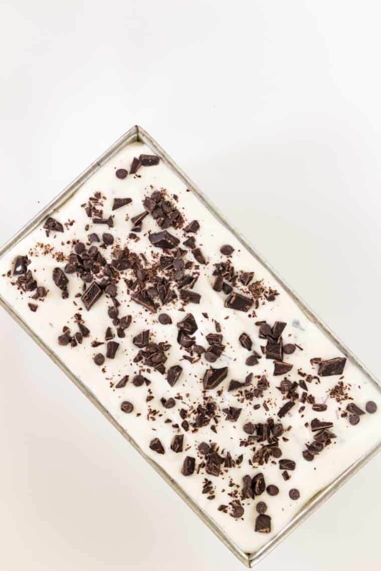 Topping the ice cream with chocolate chips.