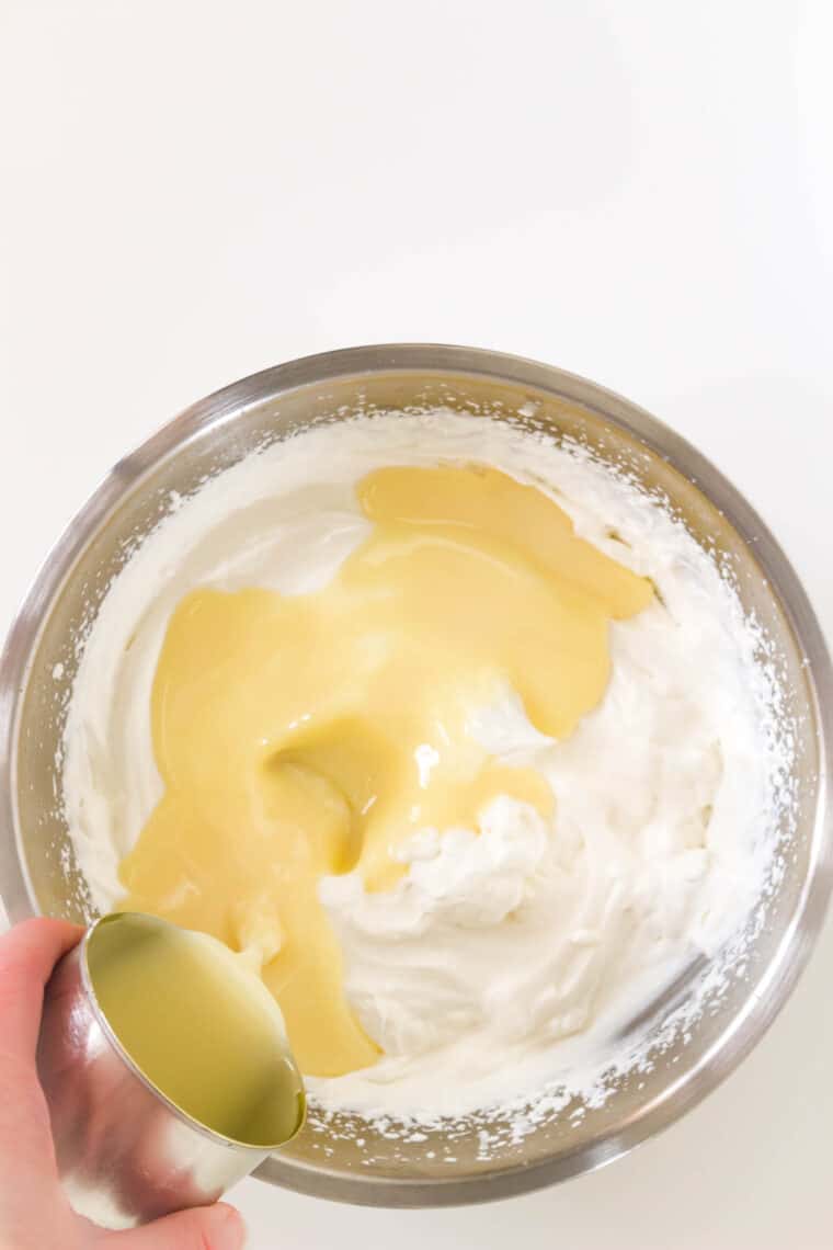 Mixing in condensed milk to whipped cream.