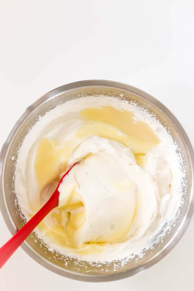 Mixing in condensed milk to whipped cream.