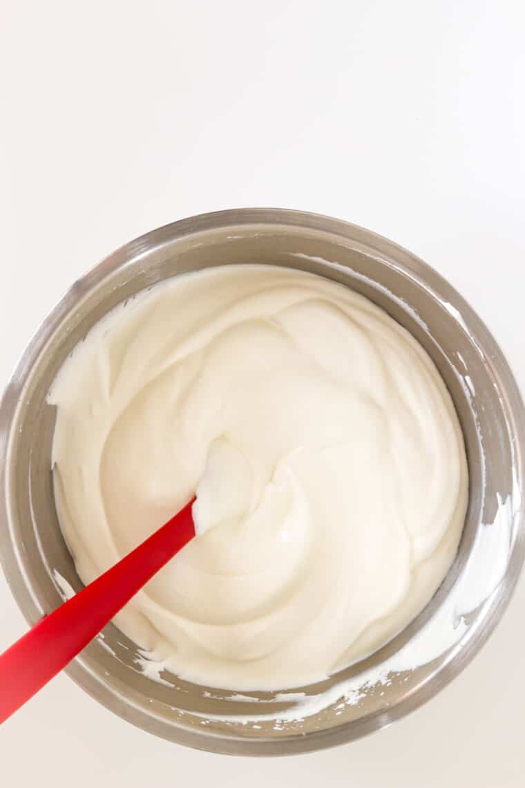 Mixing in condensed milk to whipped cream.
