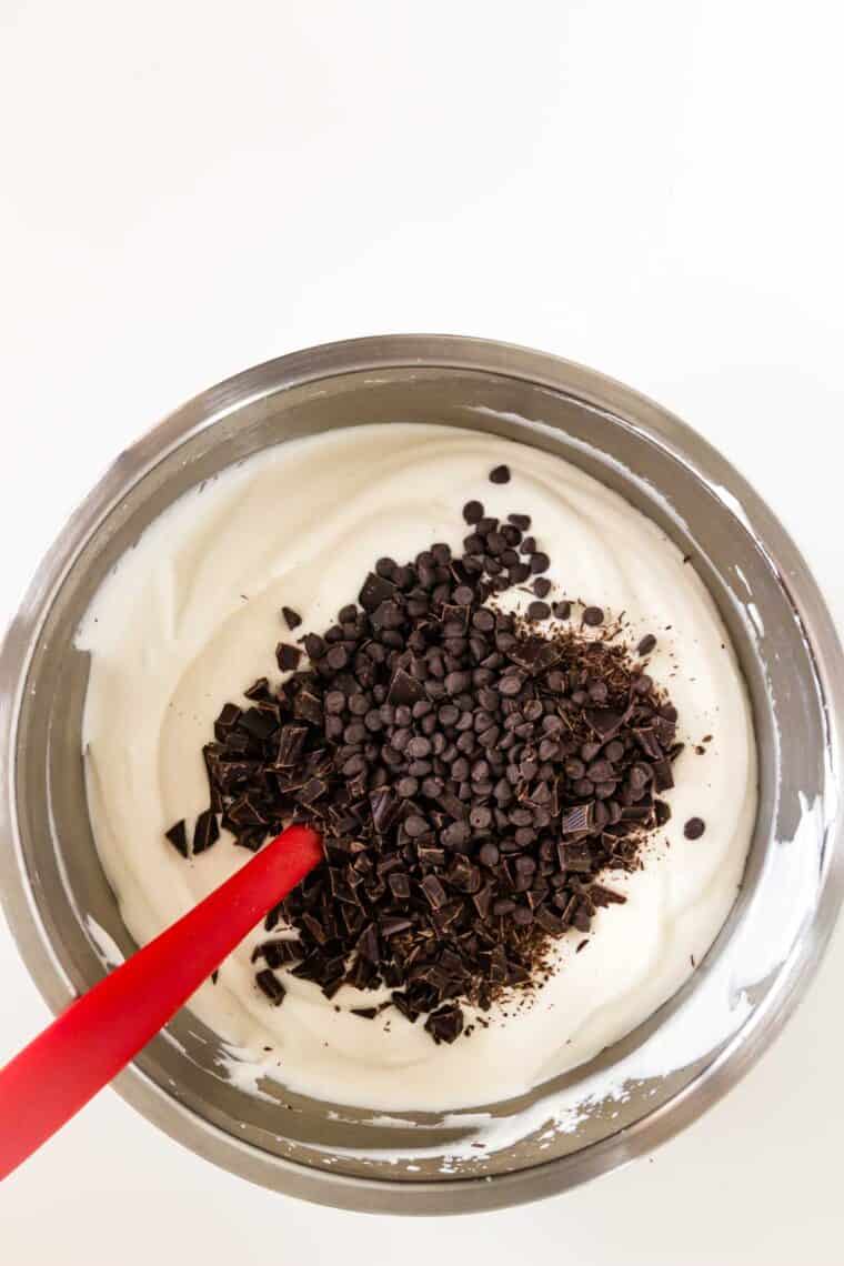 Chocolate chips on top of cream in a bowl.