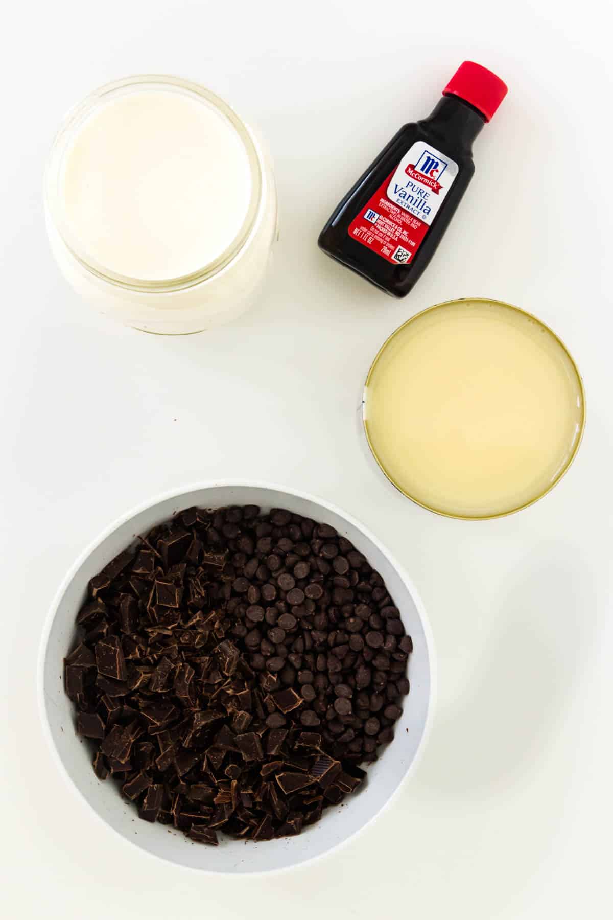 ingredients needed to make no churn chocolate chip ice cream: vanilla, cream, condensed milk, and chocolate.