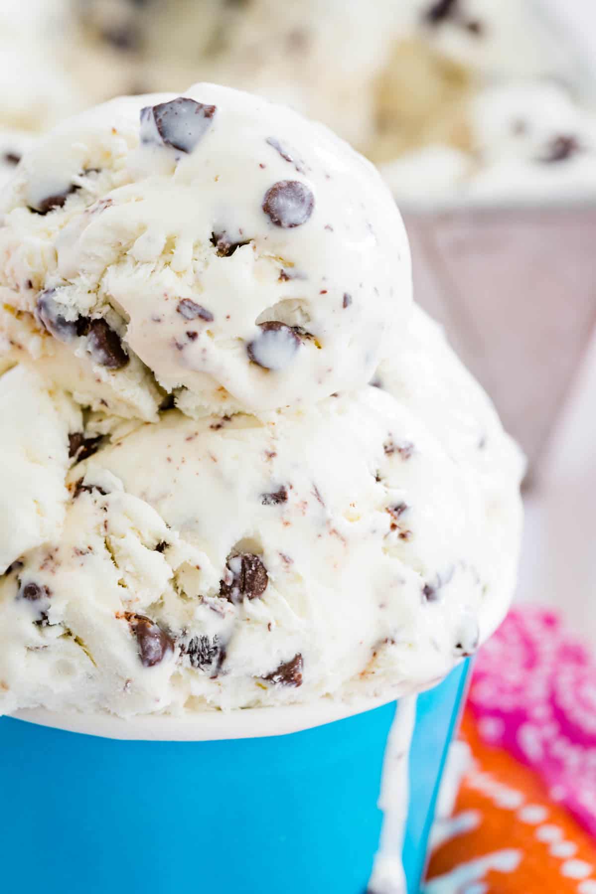 A close up shot of no churn chocolate chip ice cream in a blue cup.