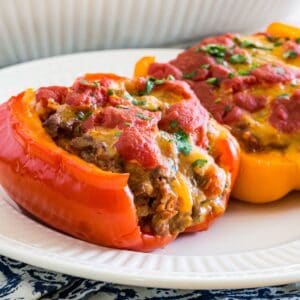 Two stuffed pepper halves on a plate.