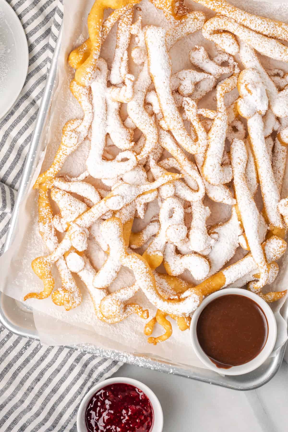Curly fried funnel cake fries on a tray.