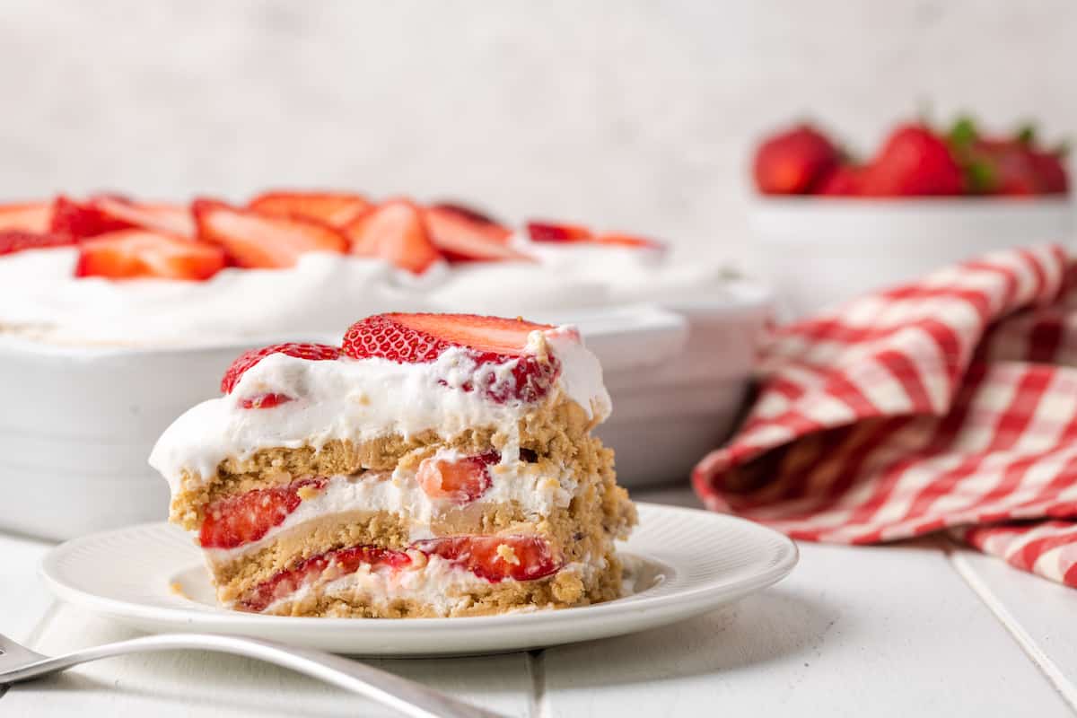 A slice of gluten-free strawberry icebox cake on a white plate.