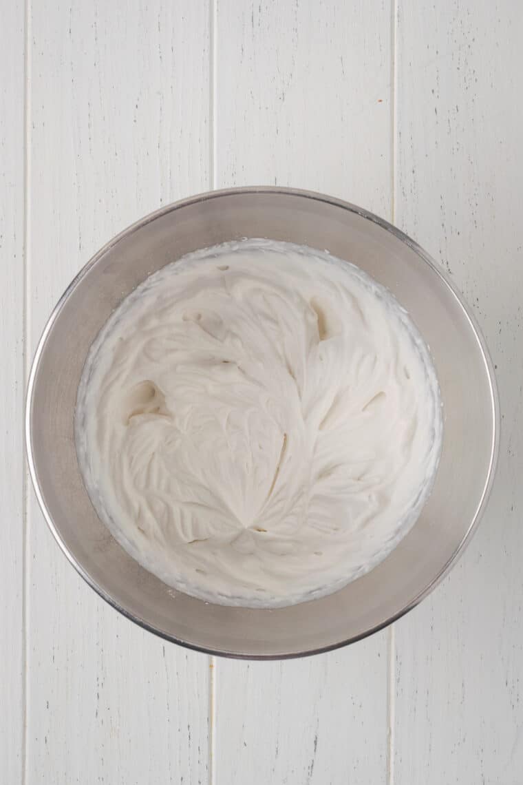 Making whipped cream in a metal bowl.