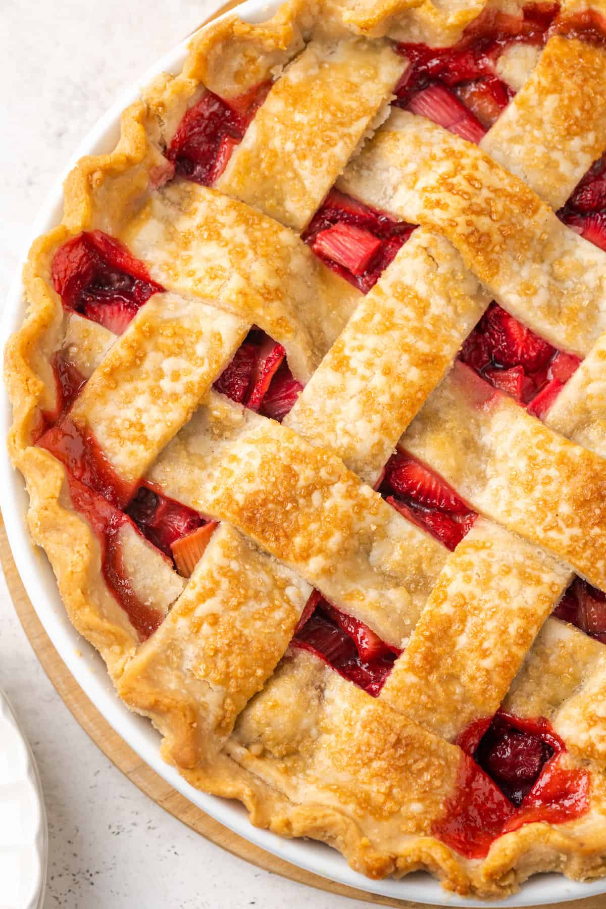 Close up of a latticed crust on a strawberry rhubarb pie.