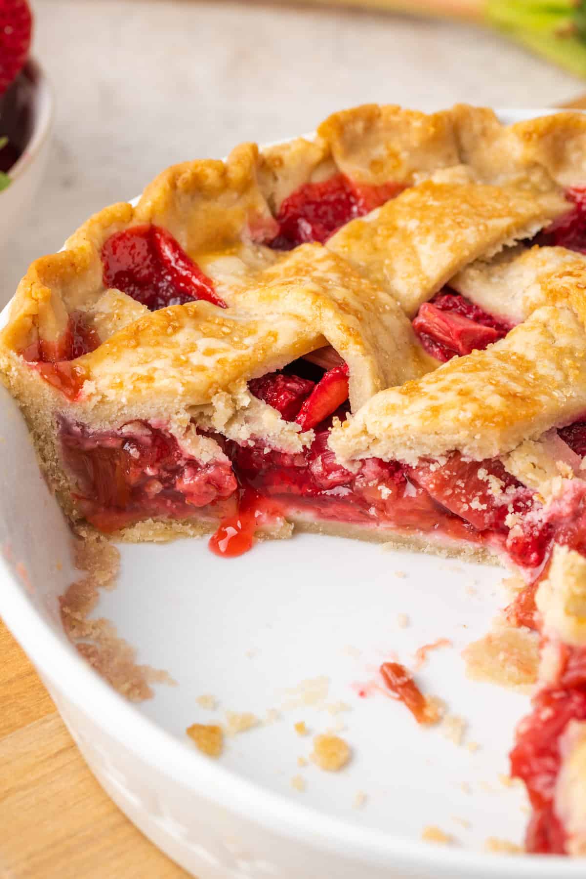 A strawberry rhubarb pie with a few slices removed.