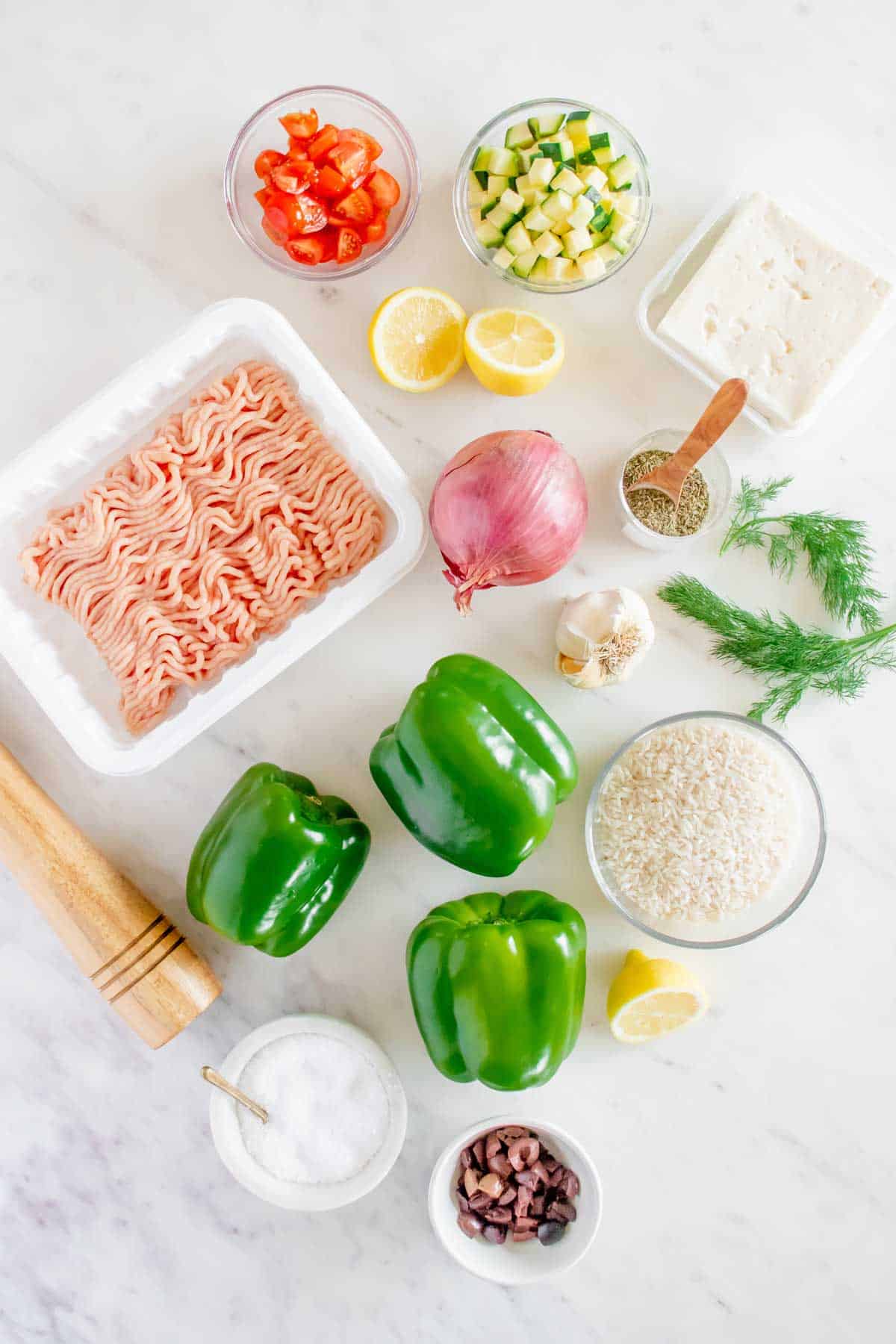 Ingredients for chicken stuffed peppers - chicken peppers, onion, lemon, feta cheese, garlic