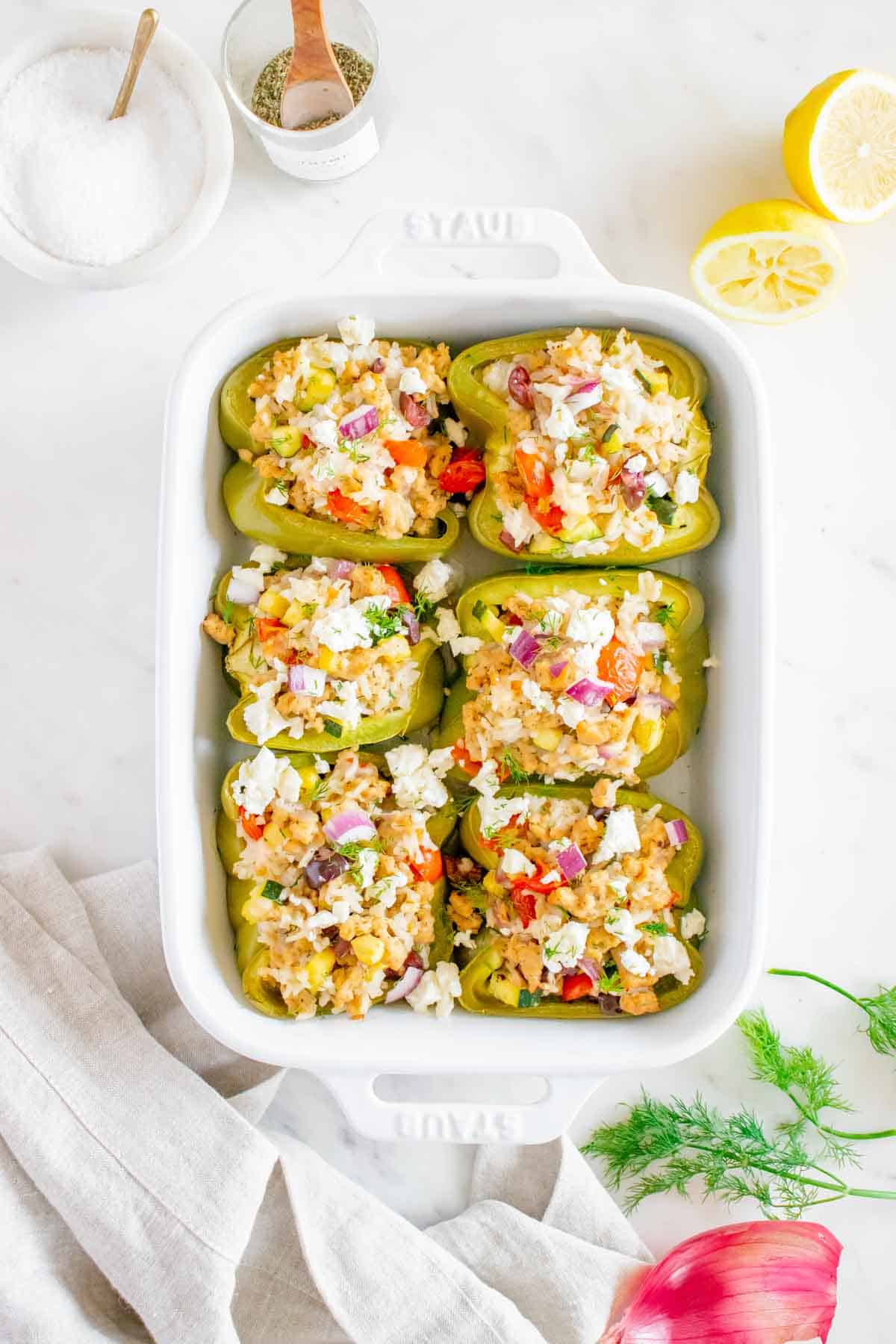 A baking dish of chicken stuffed peppers.