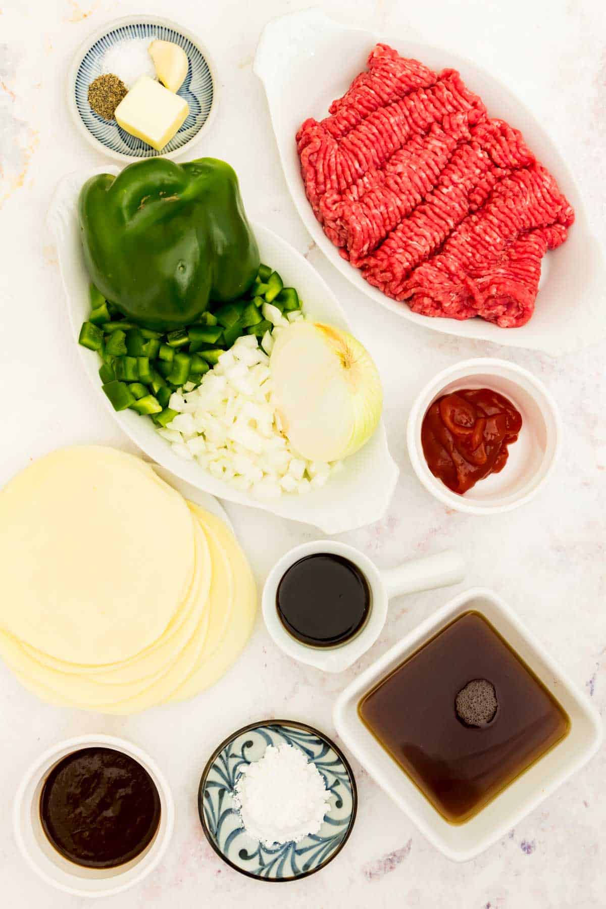 Ingredients needed for Philly cheesesteak sloppy joes: meat, peppers, onion, cheese, beef broth.