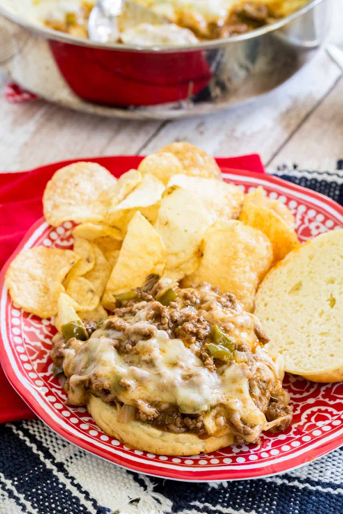 A cheesy Philly cheesesteak sloppy joe on a plate.