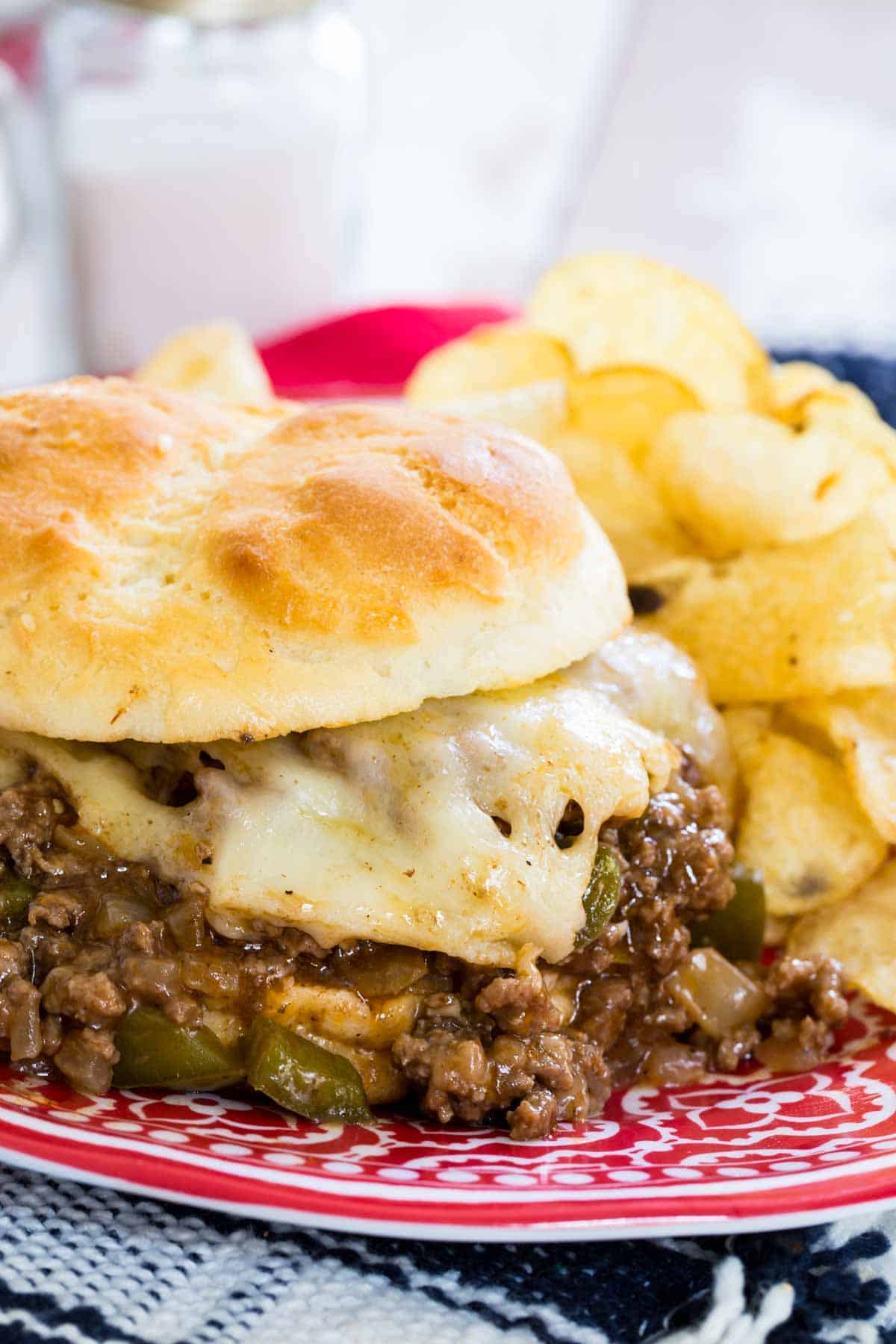 A cheesy Philly cheesesteak sloppy joe on a plate.