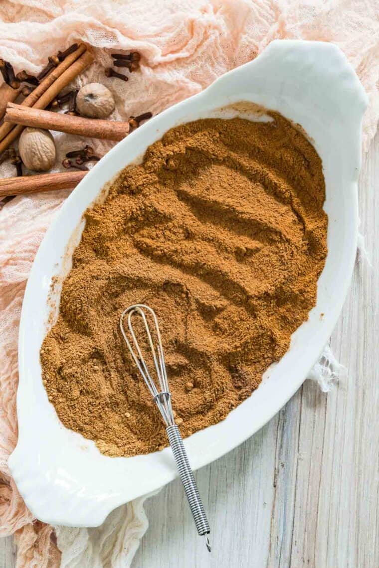 A whisk blend together spices to make pumpkin pie spice mix.