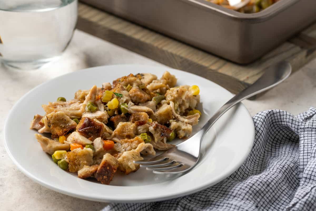A plate of chicken stuffing casserole with a fork.